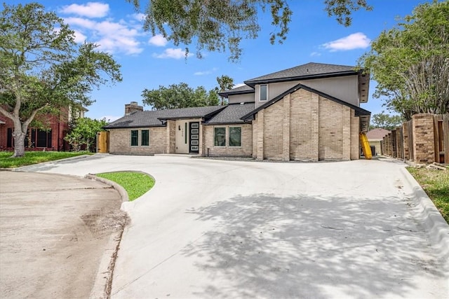 7025 Ashdown Dr, Corpus Christi, TX 78413 - view of front of house with brick siding, a chimney, and curved driveway