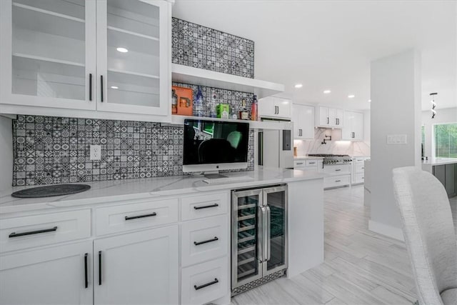 7025 Ashdown Dr, Corpus Christi, TX 78413 - bar with beverage cooler, stainless steel gas cooktop, tasteful backsplash, recessed lighting, and refrigerator