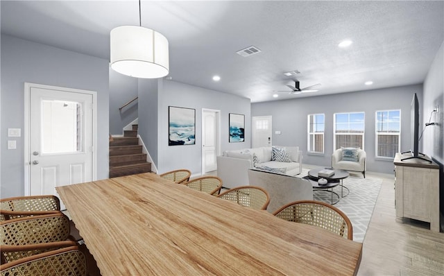 dining area featuring a textured ceiling, recessed lighting, a ceiling fan, visible vents, and stairway