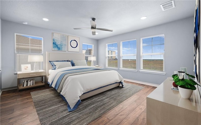 bedroom featuring recessed lighting, wood finished floors, visible vents, and baseboards