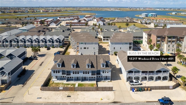 drone / aerial view featuring a residential view and a water view