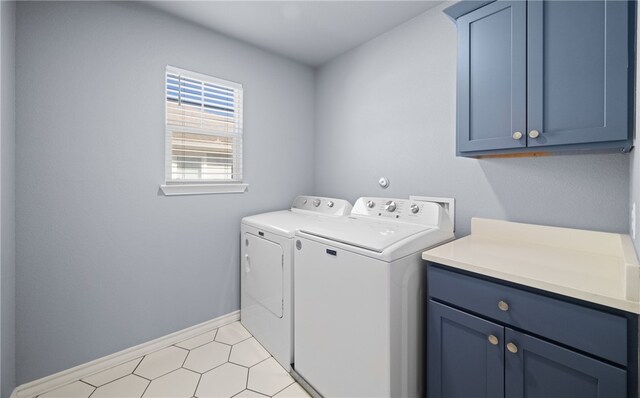 laundry room with light tile patterned floors, cabinet space, baseboards, and separate washer and dryer