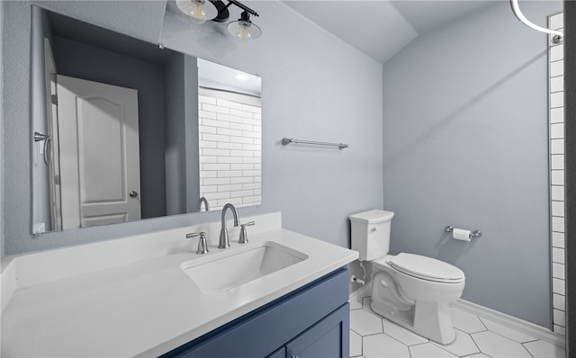 full bathroom featuring baseboards, toilet, tile patterned floors, vaulted ceiling, and vanity