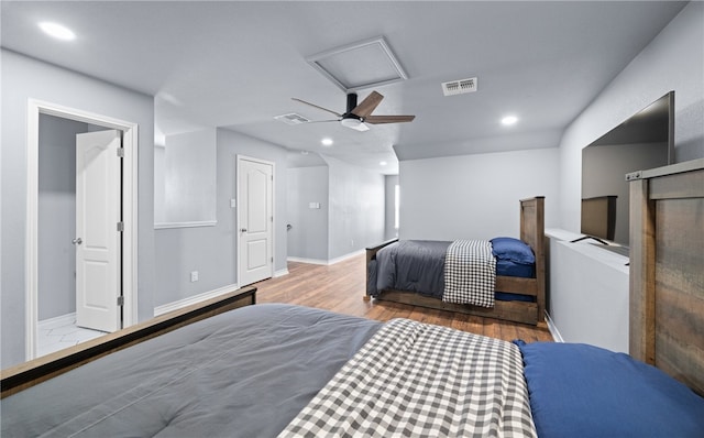 bedroom with recessed lighting, attic access, visible vents, and light wood-style floors