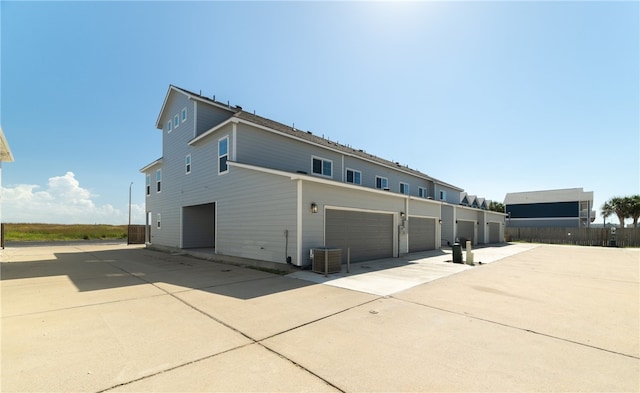 back of house with a garage and driveway