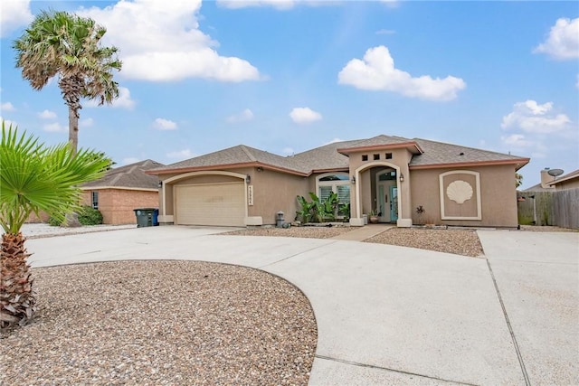13901 Laffite Dr, Corpus Christi, TX 78418 - mediterranean / spanish-style home featuring driveway, stucco siding, and a garage
