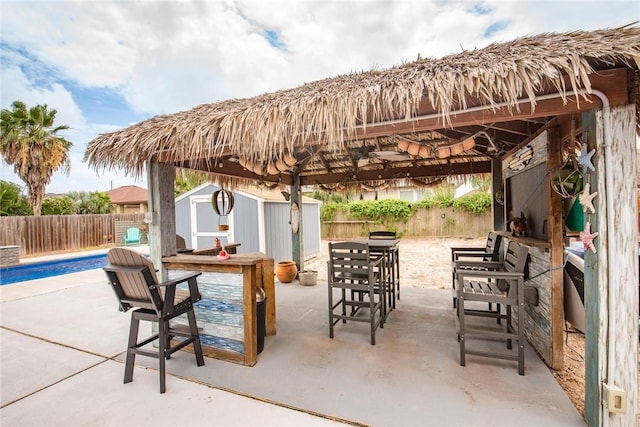 13901 Laffite Dr, Corpus Christi, TX 78418 - fenced backyard with a storage unit and a patio area