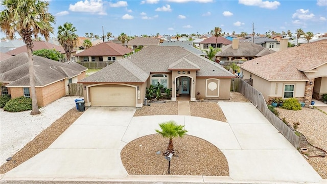 13901 Laffite Dr, Corpus Christi, TX 78418 - view of front of home featuring a residential view, stucco siding, an attached garage, roof with shingles, and concrete driveway