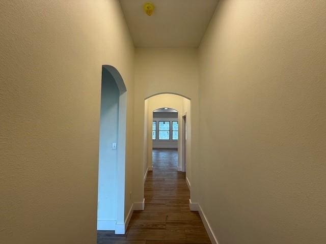 2761 Camargo Dr, Corpus Christi, TX 78415 - corridor featuring arched walkways and dark wood-style flooring