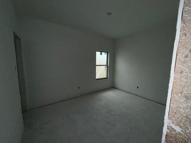 unfurnished room with concrete floors