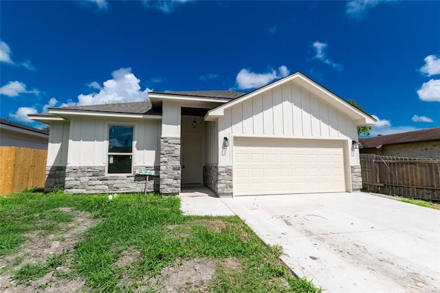 2761 Camargo Dr, Corpus Christi, TX 78415 - view of front facade featuring stone siding, a garage, driveway, a shingled roof, and board and batten siding