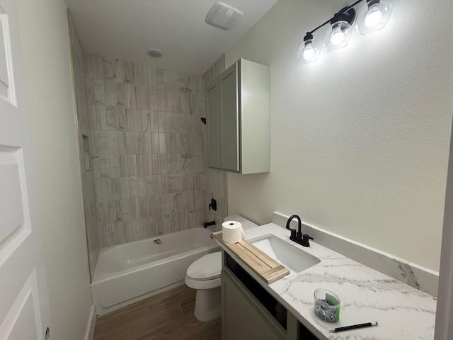 2761 Camargo Dr, Corpus Christi, TX 78415 - full bathroom featuring vanity, shower / bathtub combination, and wood finished floors