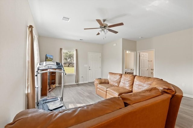 1818 16th St, Rockport, TX 78382 - living area with visible vents, baseboards, wood finished floors, and a ceiling fan