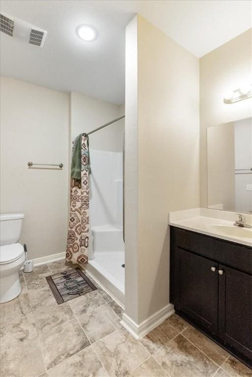 1818 16th St, Rockport, TX 78382 - full bath featuring vanity, toilet, baseboards, and a stall shower