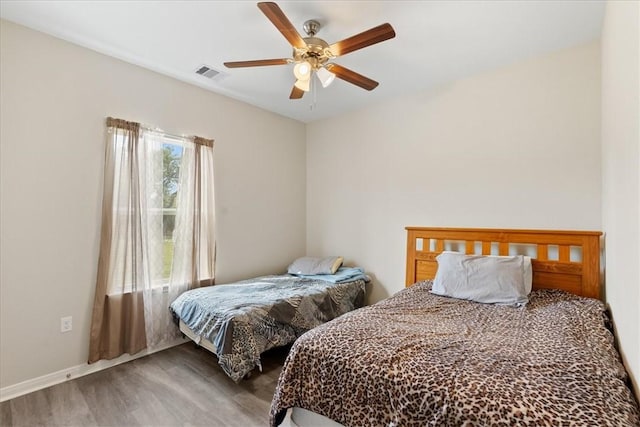 1818 16th St, Rockport, TX 78382 - bedroom with a ceiling fan, wood finished floors, and visible vents