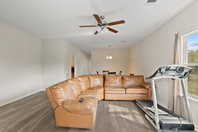 1818 16th St, Rockport, TX 78382 - living area with visible vents, baseboards, wood finished floors, and ceiling fan with notable chandelier