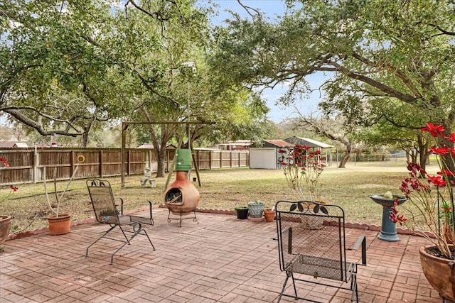 view of patio featuring a fenced backyard and an outdoor structure