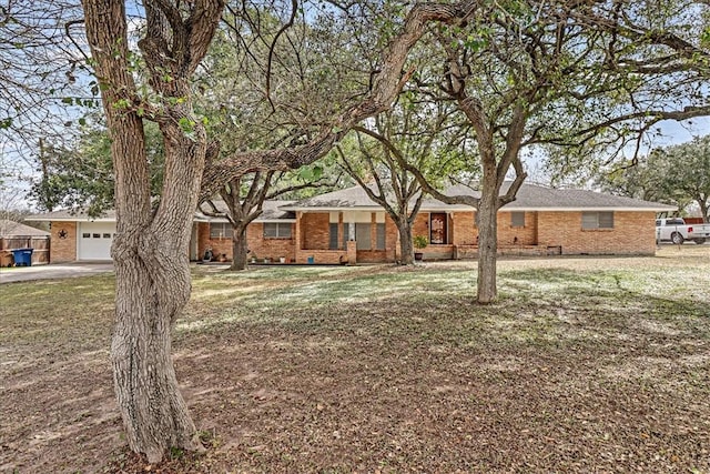 single story home featuring crawl space, a front lawn, and brick siding