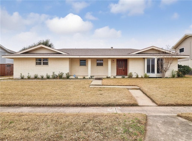 ranch-style home with a front lawn