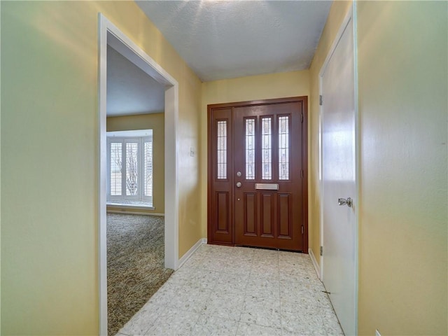 view of carpeted foyer entrance