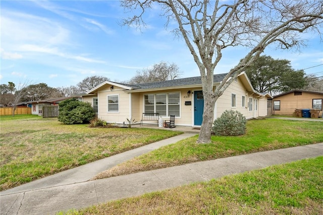 single story home featuring covered porch and a front yard