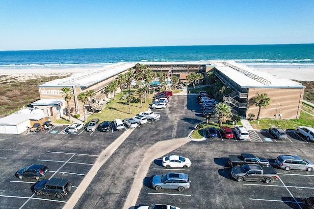 birds eye view of property featuring a beach view and a water view