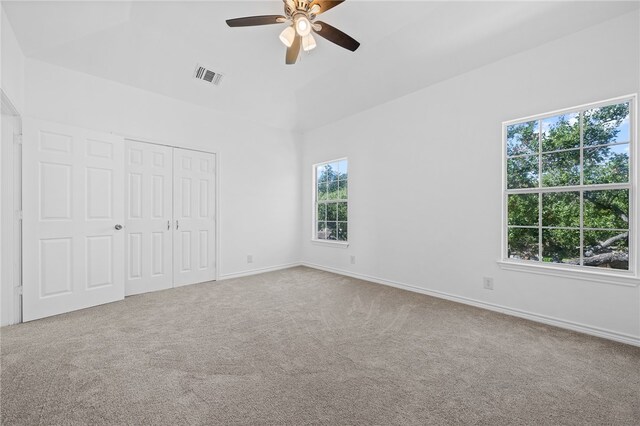 unfurnished bedroom with a closet, ceiling fan, and carpet floors