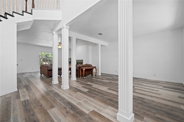 interior space featuring hardwood / wood-style flooring and decorative columns