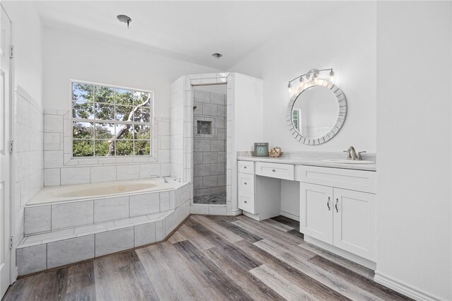 bathroom with shower with separate bathtub, wood-type flooring, and vanity