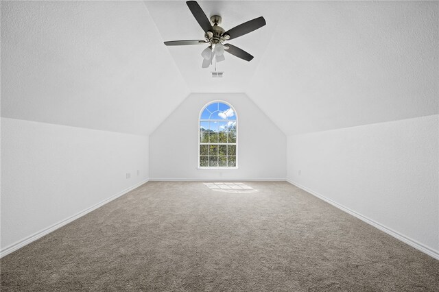 bonus room with a textured ceiling, carpet, ceiling fan, and vaulted ceiling