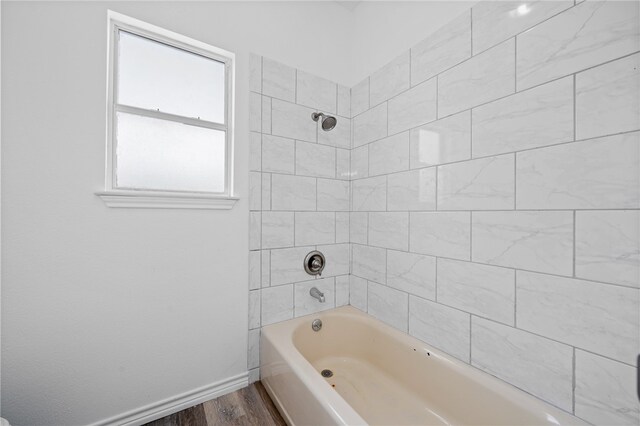 bathroom featuring tiled shower / bath and hardwood / wood-style floors