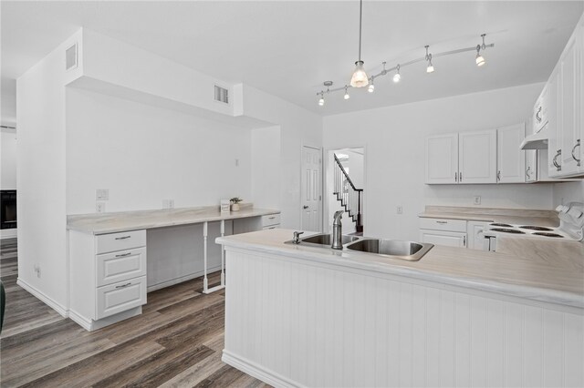 kitchen featuring white cabinetry, sink, kitchen peninsula, white range, and hanging light fixtures