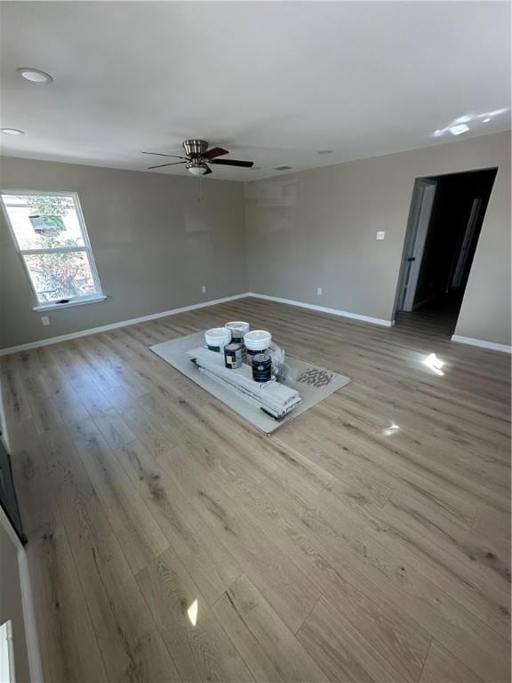 spare room featuring light hardwood / wood-style flooring and ceiling fan