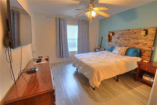 bedroom with a ceiling fan and wood finished floors