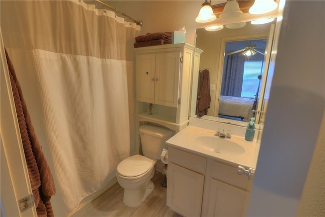 bathroom featuring ensuite bath, vanity, toilet, a ceiling fan, and wood finished floors