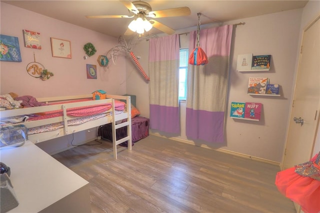 bedroom with ceiling fan and wood finished floors
