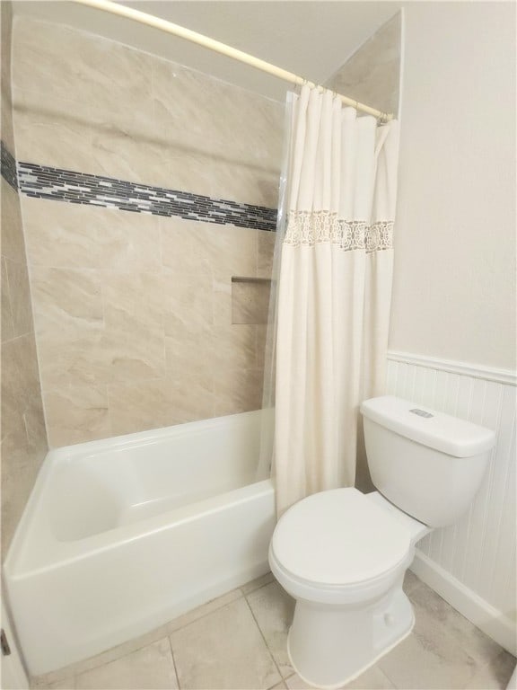 bathroom with tile patterned floors, toilet, and shower / bathtub combination with curtain