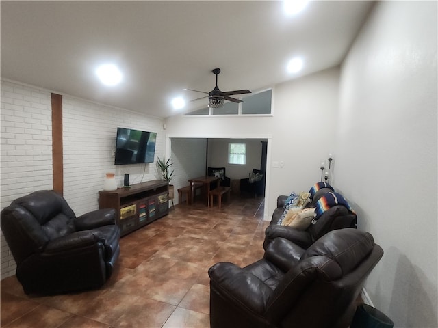 living room featuring ceiling fan, brick wall, and vaulted ceiling