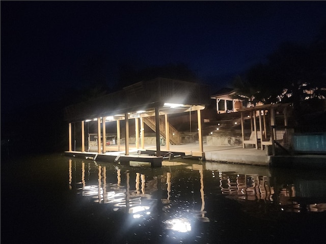 back house at twilight with a water view