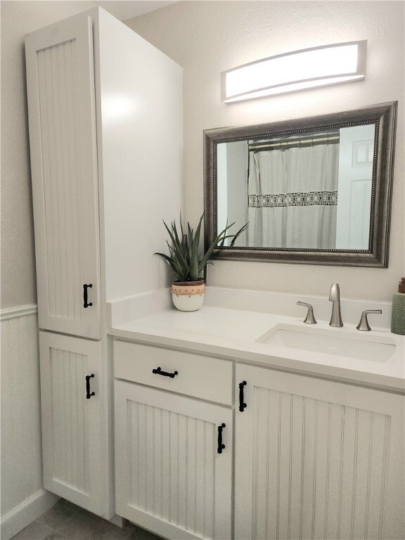 bathroom with vanity, tile patterned floors, and a shower with shower curtain