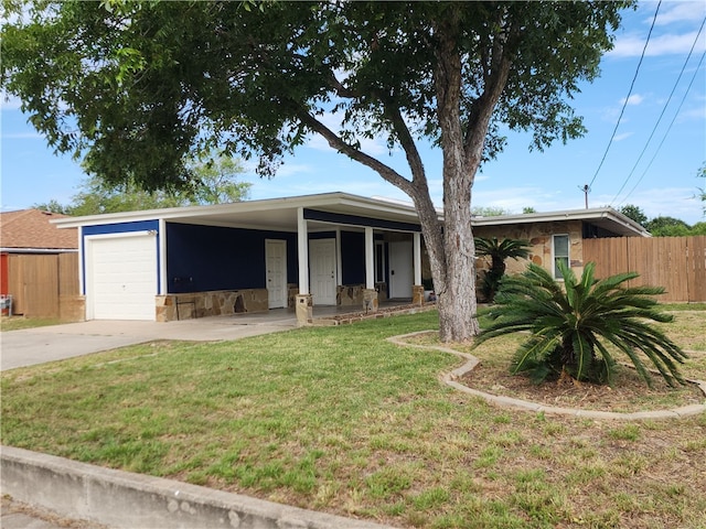 view of front of house with a garage and a front lawn