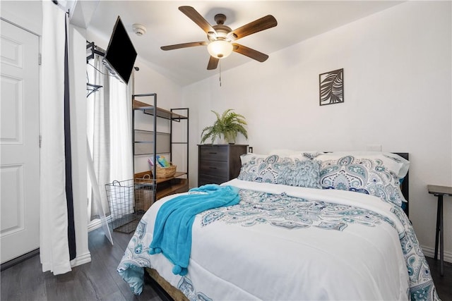 bedroom with lofted ceiling, ceiling fan, and dark wood finished floors