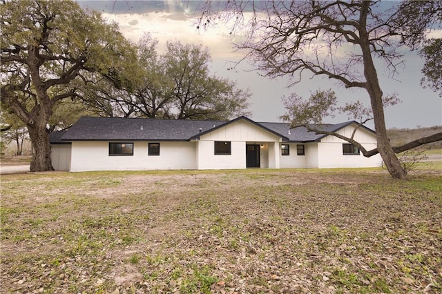 rear view of house with a yard