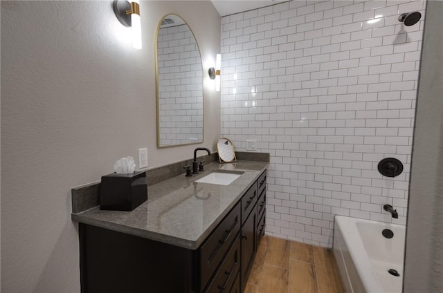 bathroom featuring vanity, shower / washtub combination, wood finished floors, and tile walls