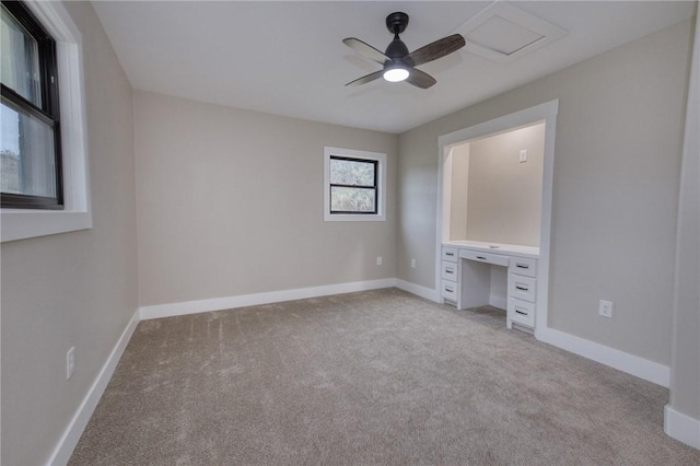 unfurnished bedroom with light colored carpet, ceiling fan, and baseboards