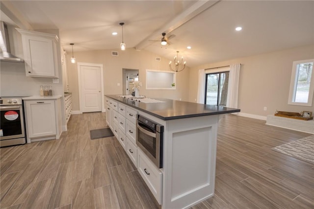 kitchen with stainless steel appliances, lofted ceiling with beams, wood tiled floor, white cabinetry, and wall chimney exhaust hood