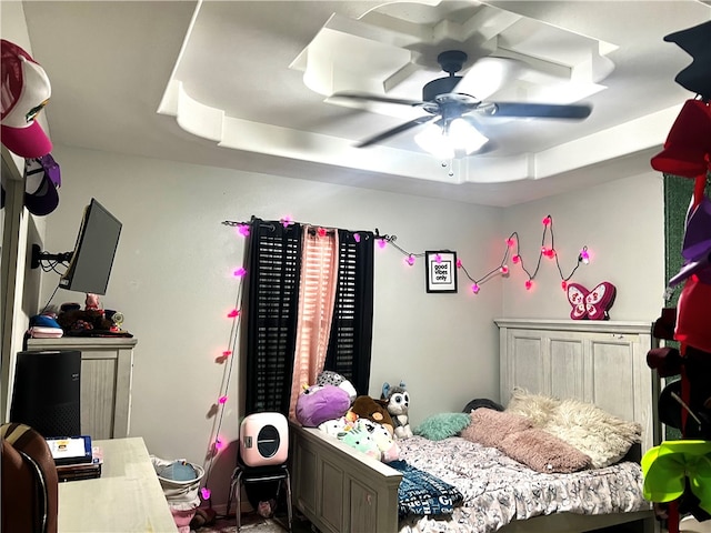 bedroom featuring ceiling fan and a tray ceiling