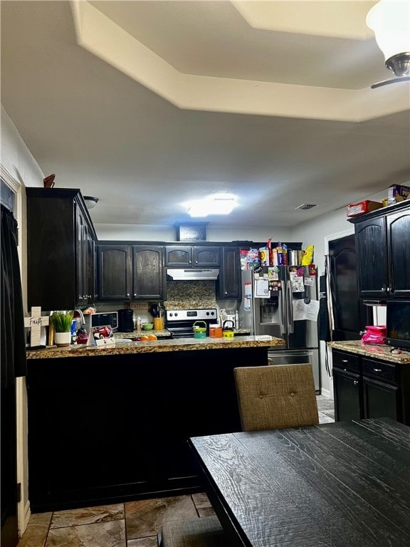 kitchen featuring stainless steel appliances and light stone counters