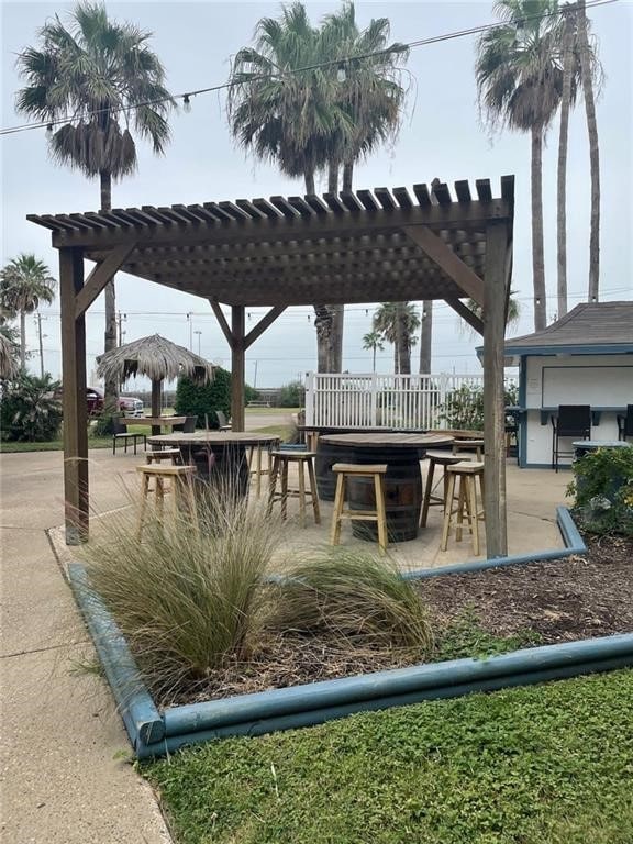 view of patio / terrace with exterior bar, area for grilling, and a pergola