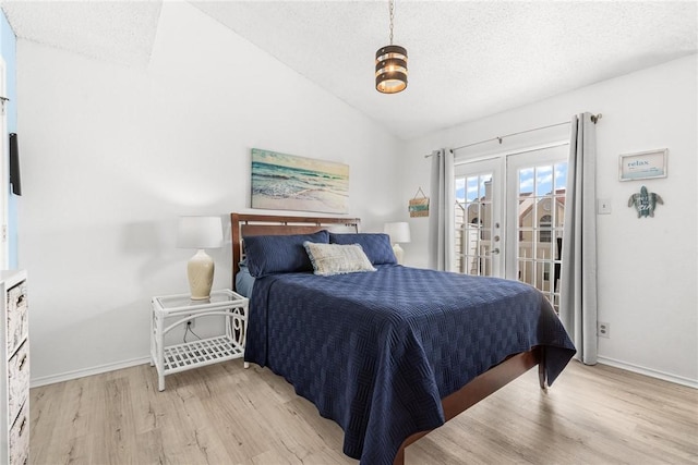 bedroom featuring access to exterior, a textured ceiling, vaulted ceiling, french doors, and light wood-type flooring